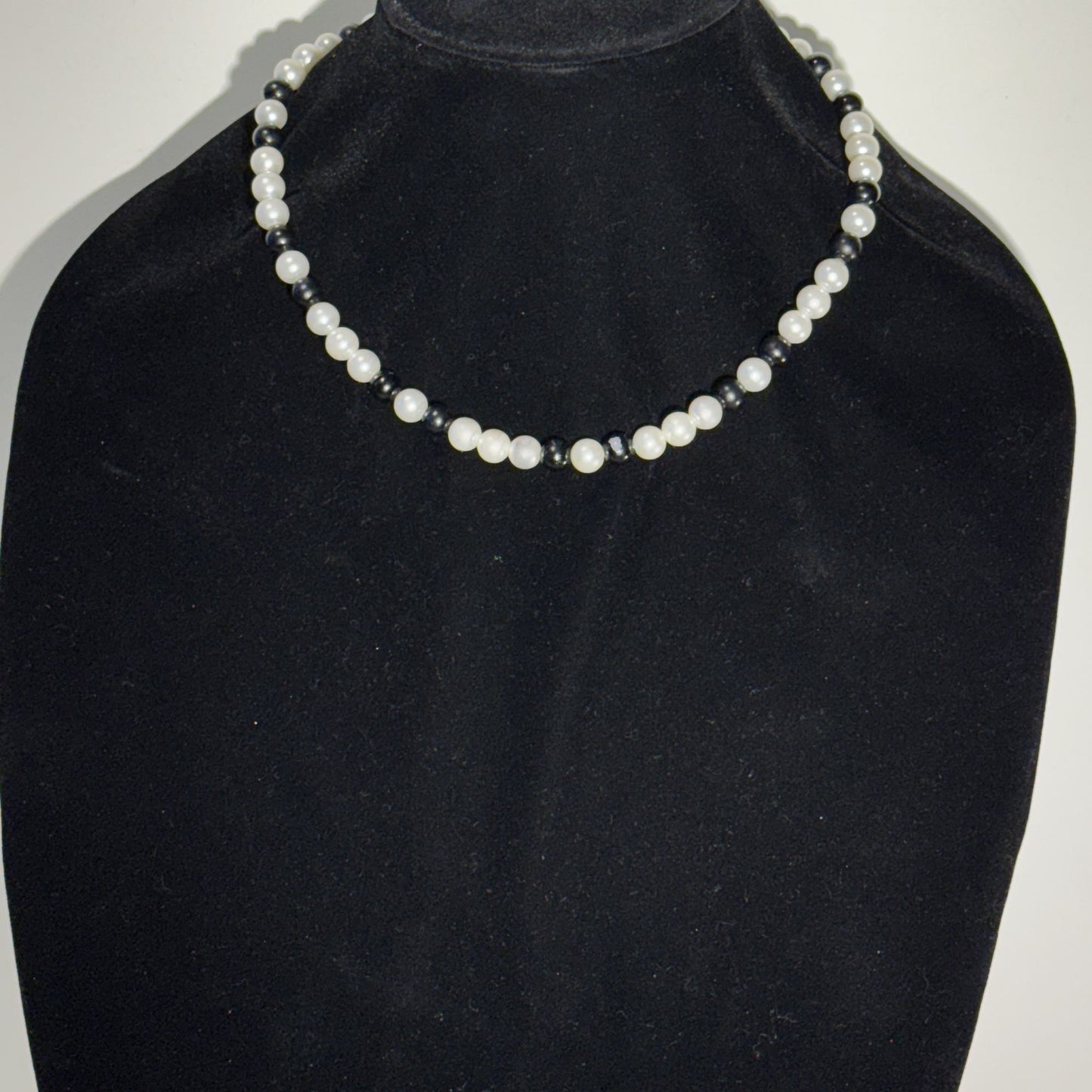 “Where classic pearls meet bold contrast.”