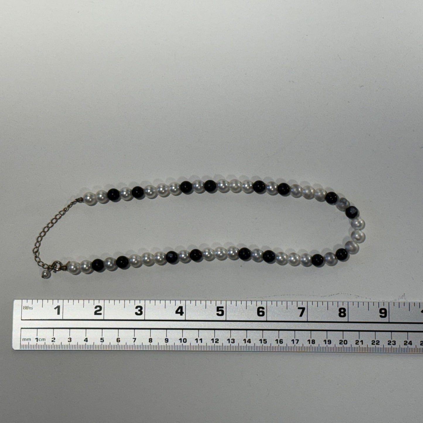“Where classic pearls meet bold contrast.”