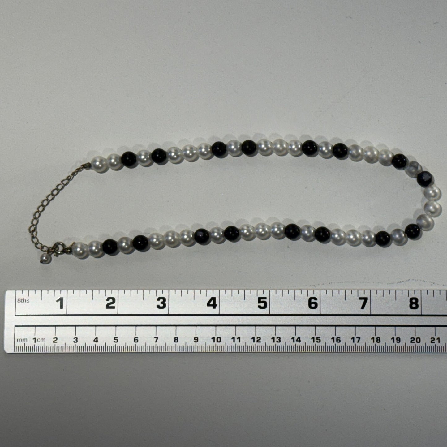 “Where classic pearls meet bold contrast.”
