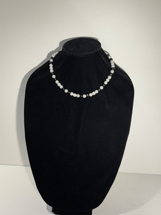 “Where classic pearls meet bold contrast.”
