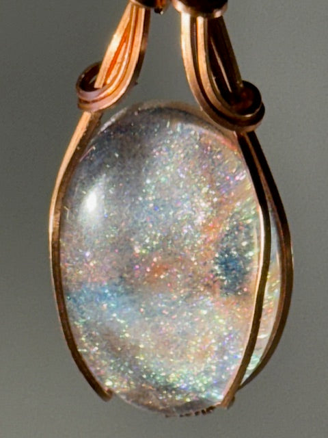 “Light captured in copper’s embrace.”
